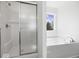Shower and bath include a window for natural lighting at 1033 Fuller Ln, Shelbyville, IN 46176