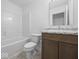 Bright bathroom with a modern vanity, toilet, tub, and vinyl floors at 1033 Fuller Ln, Shelbyville, IN 46176