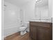 Bright bathroom featuring a shower-tub combo and vanity with a granite countertop at 1033 Fuller Ln, Shelbyville, IN 46176