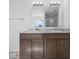 Bathroom with double sink vanity, granite countertop, and large mirror at 1033 Fuller Ln, Shelbyville, IN 46176