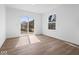 Bright bedroom with sliding glass door access and wood-look vinyl flooring at 1033 Fuller Ln, Shelbyville, IN 46176