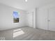 Bright carpeted bedroom with a window and closet provides a comfortable space at 1033 Fuller Ln, Shelbyville, IN 46176