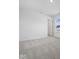 Bright bedroom with neutral carpet, white walls, and a glimpse of a closet through an open door at 1033 Fuller Ln, Shelbyville, IN 46176