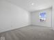 Cozy bedroom with plush carpeting and a bright window offering natural light at 1033 Fuller Ln, Shelbyville, IN 46176