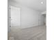 Bright, carpeted bedroom featuring a closet and an open doorway at 1033 Fuller Ln, Shelbyville, IN 46176