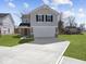 Charming two-story home featuring a spacious driveway and an attached two-car garage at 1033 Fuller Ln, Shelbyville, IN 46176