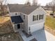 A new two-story home with light gray siding, black shutters and new concrete driveway at 1033 Fuller Ln, Shelbyville, IN 46176