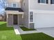 A close up of the home's facade, featuring a two-car garage and landscaped lawn at 1033 Fuller Ln, Shelbyville, IN 46176