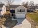 Charming two-story home featuring a gray exterior, new concrete driveway and attached two car garage at 1033 Fuller Ln, Shelbyville, IN 46176