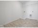 Bright laundry room with white walls, vinyl floor, and a washer/dryer hookup at 1033 Fuller Ln, Shelbyville, IN 46176