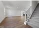 Open-concept living room flows into the kitchen with modern stair railing at 1033 Fuller Ln, Shelbyville, IN 46176