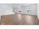 Spacious living room with sleek flooring, natural light, and staircase at 1033 Fuller Ln, Shelbyville, IN 46176