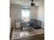 Bright bedroom featuring a ceiling fan, large window, neutral walls, and modern decor with a desk and cage at 12145 Bubbling Brook Dr # 600, Fishers, IN 46038