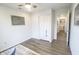 Cozy bedroom features a ceiling fan, spacious closet, wood floors and view to the laundry room at 12145 Bubbling Brook Dr # 600, Fishers, IN 46038