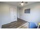 Bright bedroom with modern ceiling fan, wood floors, and ample closet space for comfortable living at 12145 Bubbling Brook Dr # 600, Fishers, IN 46038