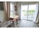 Bright dining area with sliding glass doors to deck, offering great views, modern chairs and laminate floor at 12145 Bubbling Brook Dr # 600, Fishers, IN 46038