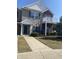 Inviting home featuring a covered entryway, green shutters, and a second-story balcony with white railings at 12145 Bubbling Brook Dr # 600, Fishers, IN 46038