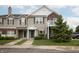 Inviting townhouse with a manicured lawn, tan siding, brick features, green trim, and a cozy balcony at 12145 Bubbling Brook Dr # 600, Fishers, IN 46038