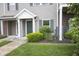 Well-maintained townhouse with manicured landscaping, green door and trim, and neutral siding at 12145 Bubbling Brook Dr # 600, Fishers, IN 46038