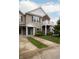 Attractive townhome featuring tan siding, a private balcony, a well-maintained lawn, and a convenient driveway at 12145 Bubbling Brook Dr # 600, Fishers, IN 46038