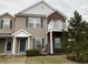 Inviting two-story townhome with brick accents, a private balcony, and a beautifully landscaped front yard at 12145 Bubbling Brook Dr # 600, Fishers, IN 46038