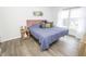 Cozy main bedroom features a plush bed, ample natural light, and stylish wood-look flooring at 12145 Bubbling Brook Dr # 600, Fishers, IN 46038