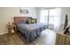 Cozy main bedroom features a plush bed, ample natural light, and stylish wood-look flooring at 12145 Bubbling Brook Dr # 600, Fishers, IN 46038