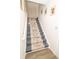 Carpeted staircase with decorative runner and white trim, leading to the upper level of the home at 12145 Bubbling Brook Dr # 600, Fishers, IN 46038