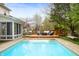 Backyard featuring a sparkling in-ground pool and a spacious wooden deck with outdoor seating at 12512 Geist Cove Dr, Indianapolis, IN 46236