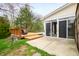 Backyard featuring a wooden deck with outdoor seating, a pool, and a concrete patio at 12512 Geist Cove Dr, Indianapolis, IN 46236