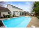 Backyard featuring a sparkling in-ground pool, wooden deck and a well-maintained lawn at 12512 Geist Cove Dr, Indianapolis, IN 46236
