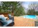 Deck area offering comfortable seating and a view of the pool and landscaped backyard at 12512 Geist Cove Dr, Indianapolis, IN 46236