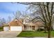 Charming two-story brick home featuring an attached garage and a well-manicured front lawn at 12512 Geist Cove Dr, Indianapolis, IN 46236