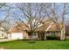 Traditional two-story home with brick and siding, a well-kept lawn, and mature landscaping at 12512 Geist Cove Dr, Indianapolis, IN 46236