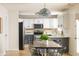 Modern kitchen featuring stainless steel appliances, custom cabinets, an island with seating, and natural light at 12512 Geist Cove Dr, Indianapolis, IN 46236