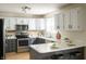 Beautiful kitchen with stainless steel appliances, two-tone cabinets, quartz countertop, and modern fixtures at 12512 Geist Cove Dr, Indianapolis, IN 46236