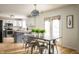 Bright kitchen and dining area with natural light, a rustic table, and stainless steel appliances at 12512 Geist Cove Dr, Indianapolis, IN 46236