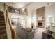 Spacious living room with a soaring brick fireplace, open floor plan, and staircase at 12512 Geist Cove Dr, Indianapolis, IN 46236