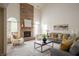 Bright living room featuring a brick fireplace, comfortable seating, and stylish decor at 12512 Geist Cove Dr, Indianapolis, IN 46236