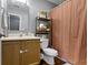 Bathroom with neutral decor, featuring a shower/tub combo and wood cabinets at 12612 Clearview Ln, Indianapolis, IN 46236