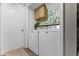 Bright laundry area features a Maytag washer and dryer, upper cabinets and stylish floral wallpaper at 12612 Clearview Ln, Indianapolis, IN 46236