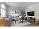 Comfortable living room featuring a large sectional sofa, natural light, and modern décor at 12612 Clearview Ln, Indianapolis, IN 46236
