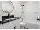Modern bathroom with black granite countertop, updated sink and shower with tub at 1319 Brookside Dr, Columbus, IN 47201