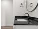 Bathroom featuring black faucet, granite counters, a black towel ring and mirror at 1319 Brookside Dr, Columbus, IN 47201
