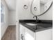 Modern bathroom features a black granite countertop and updated fixtures at 1319 Brookside Dr, Columbus, IN 47201