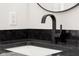 Close-up of black faucet and granite countertop in a modern bathroom at 1319 Brookside Dr, Columbus, IN 47201