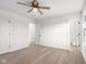 Bright bedroom featuring neutral walls, modern ceiling fan, and light wood-look flooring at 1319 Brookside Dr, Columbus, IN 47201