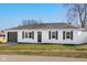 A view of the home's exterior elevation, including the yard, garage, and front door at 1319 Brookside Dr, Columbus, IN 47201
