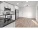Bright kitchen with white cabinets, stainless steel appliances, black countertops, and modern lighting at 1319 Brookside Dr, Columbus, IN 47201