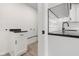 Laundry room and kitchen featuring matching modern black hardware and granite countertops at 1319 Brookside Dr, Columbus, IN 47201